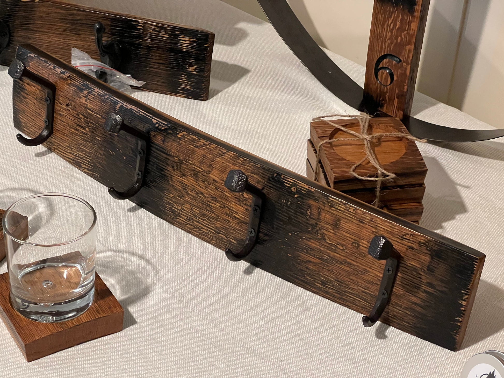 Coat rack, bourbon barrel stave, 4 rustic hooks, black bent railroad ties nail
bourbon barrel stave clock, barrel stave coasters, barrel stave coaster with glass